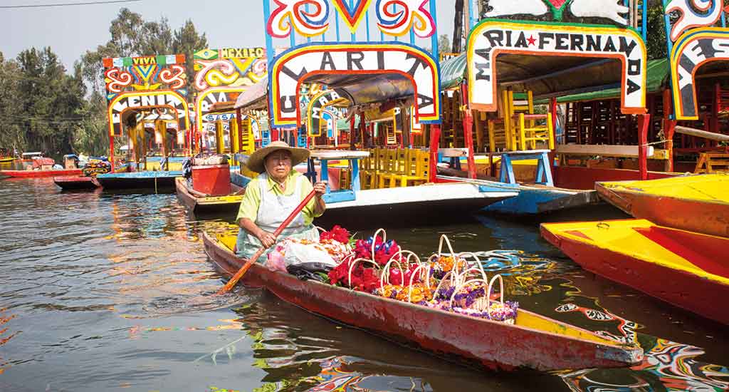 Trajinera boats in Xoxhimilco canal Mexico