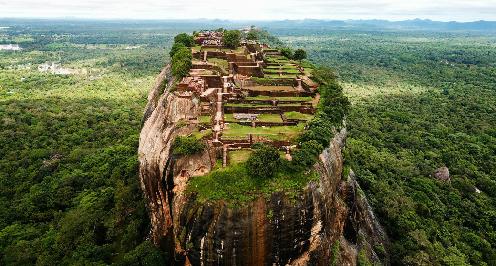 Lush forests surround the massive and ancient Lion Rock in Sigiriya