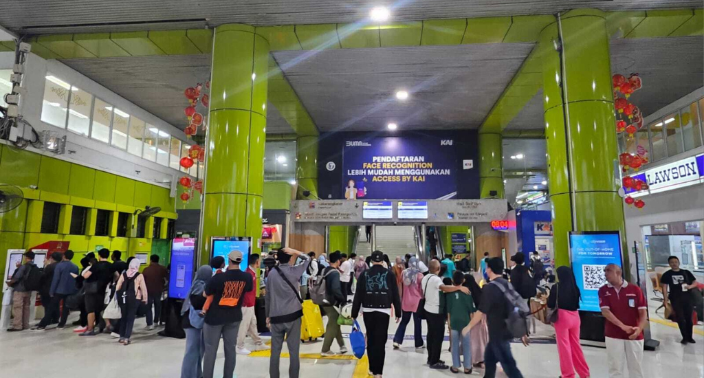 People queue for ticket counters at a train station in Indonesia